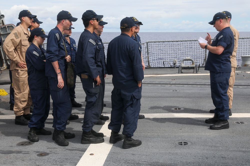 Sailors aboard the USS John Finn conduct a sea and anchor detail in Apra Harbor, Guam