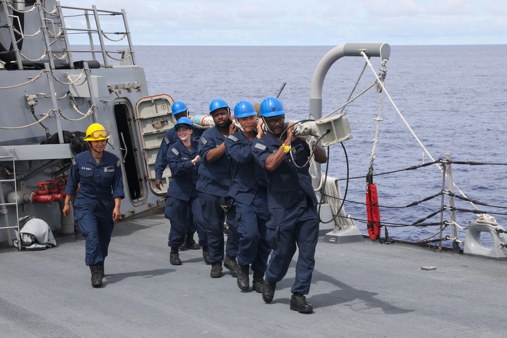 Sailors aboard the USS John Finn conduct a sea and anchor detail in Apra Harbor, Guam