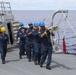 Sailors aboard the USS John Finn conduct a sea and anchor detail in Apra Harbor, Guam