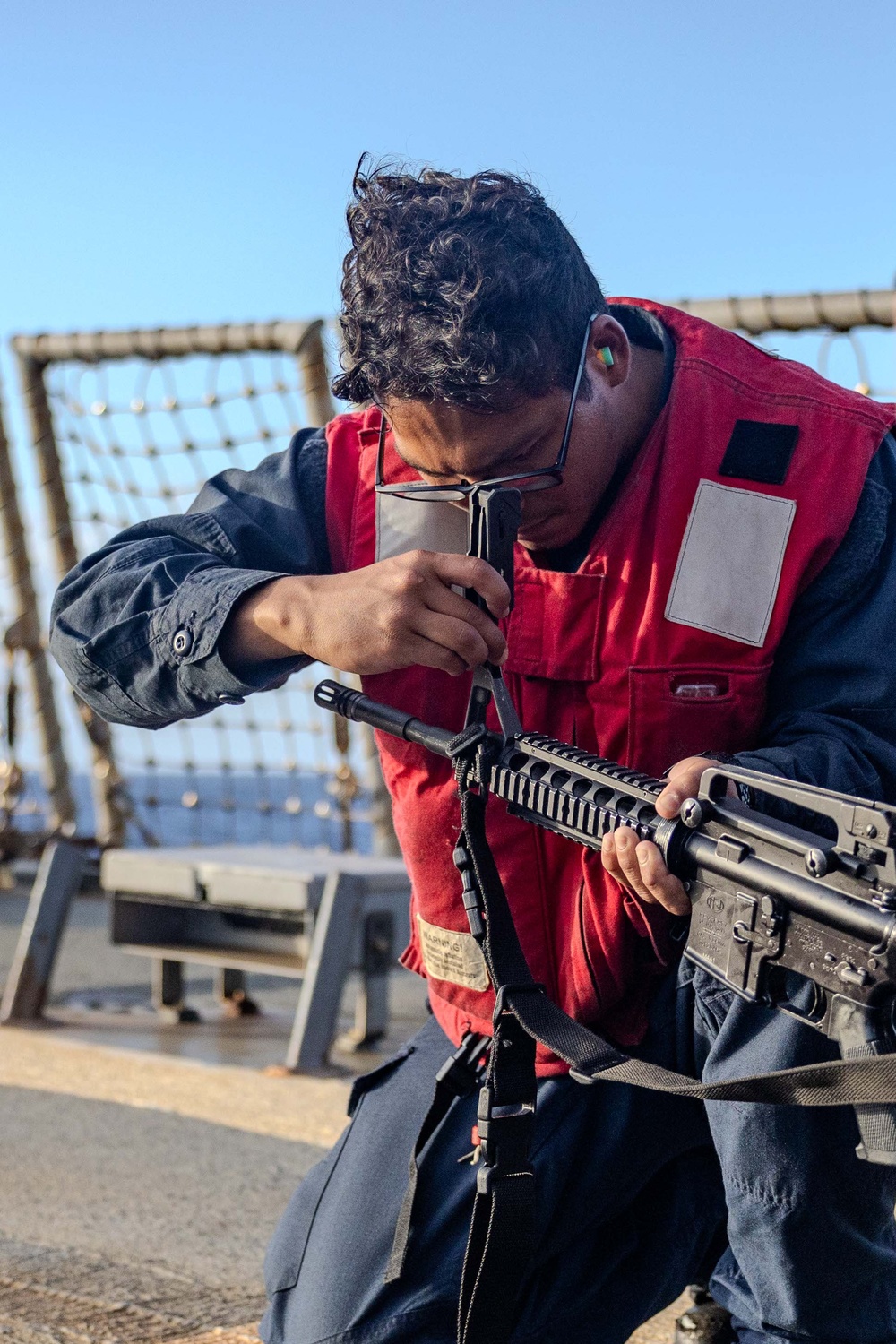 USS Ralph Johnson Sailors Participate in a Small Arms Weapons Qualification