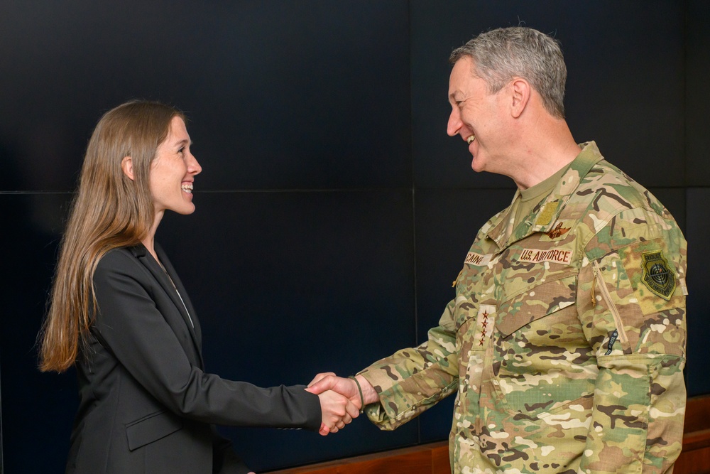 CJCS Gen. Caine greets and presents coins U.S. Africa Command team members