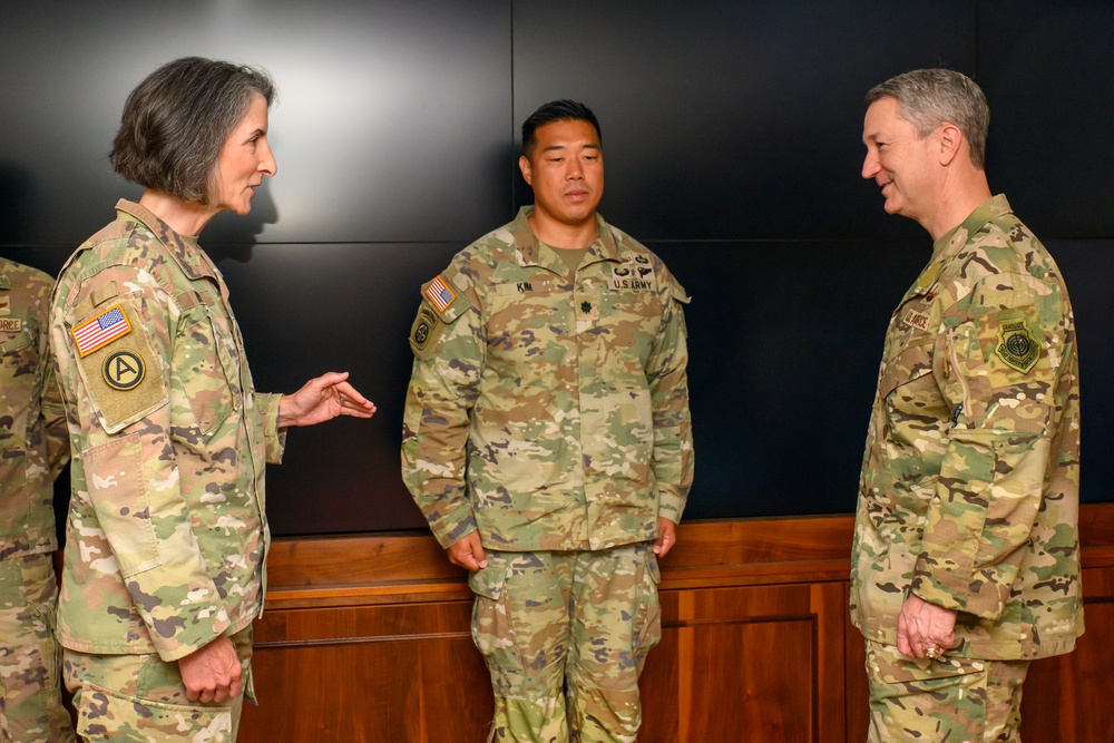 CJCS Gen. Caine greets and presents coins U.S. Africa Command team members