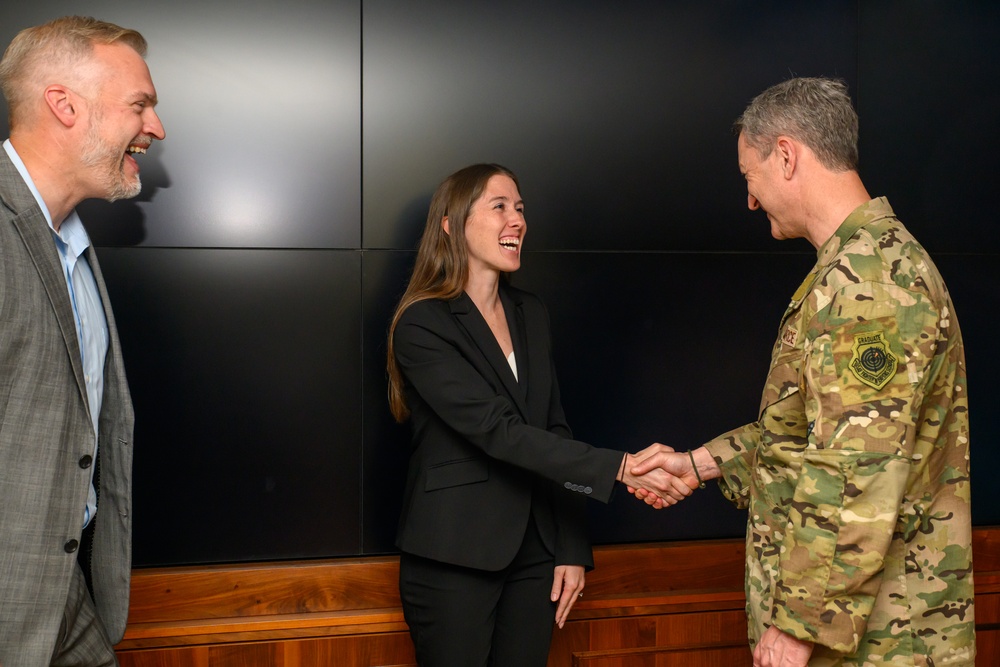 CJCS Gen. Caine greets and presents coins U.S. Africa Command team members