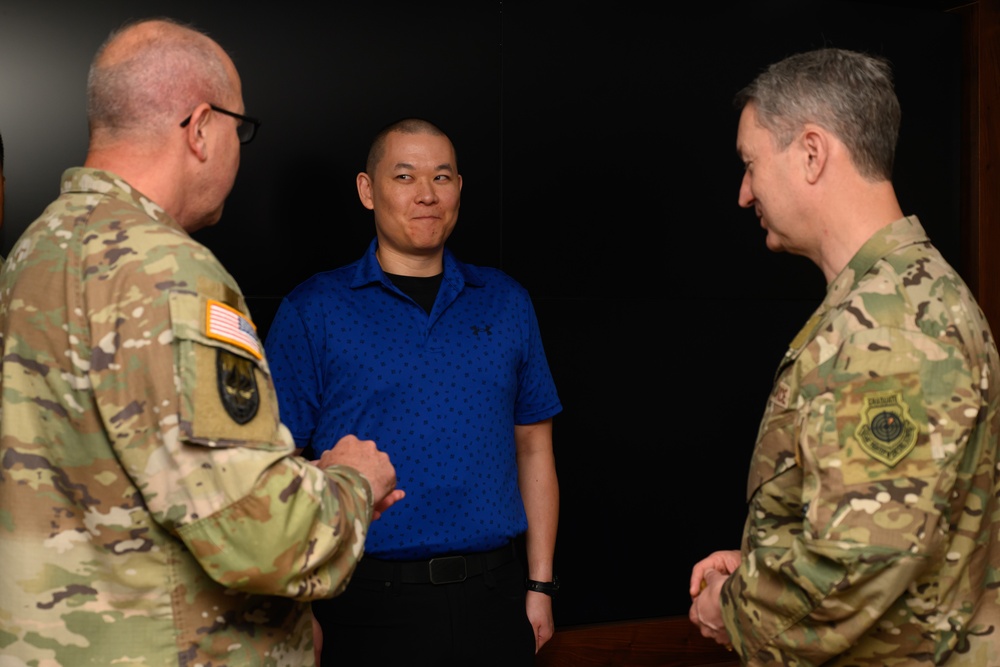 CJCS Gen. Caine greets and presents coins U.S. Africa Command team members