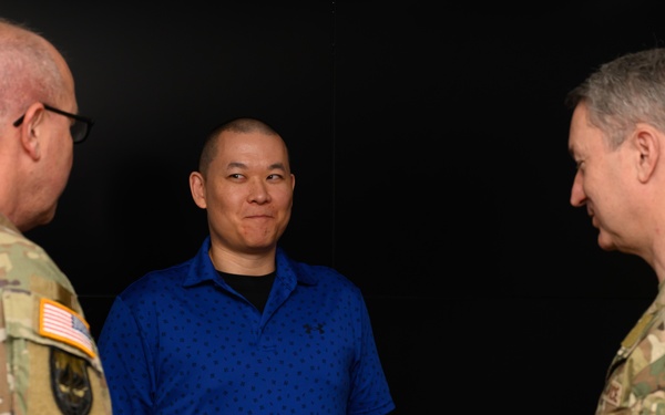 CJCS Gen. Caine greets and presents coins U.S. Africa Command team members