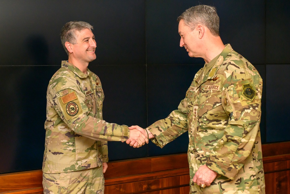 CJCS Gen. Caine greets and presents coins U.S. Africa Command team members