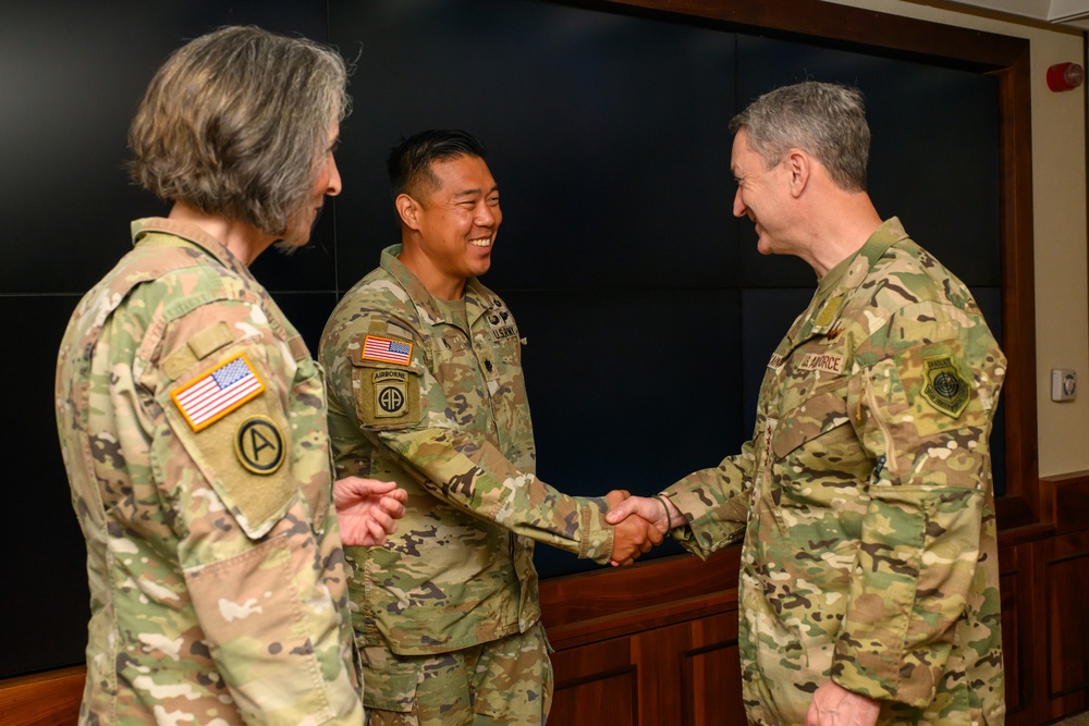 CJCS Gen. Caine greets and presents coins U.S. Africa Command team members
