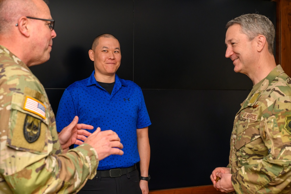 CJCS Gen. Caine greets and presents coins U.S. Africa Command team members