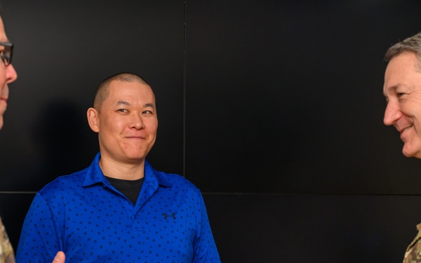 CJCS Gen. Caine greets and presents coins U.S. Africa Command team members