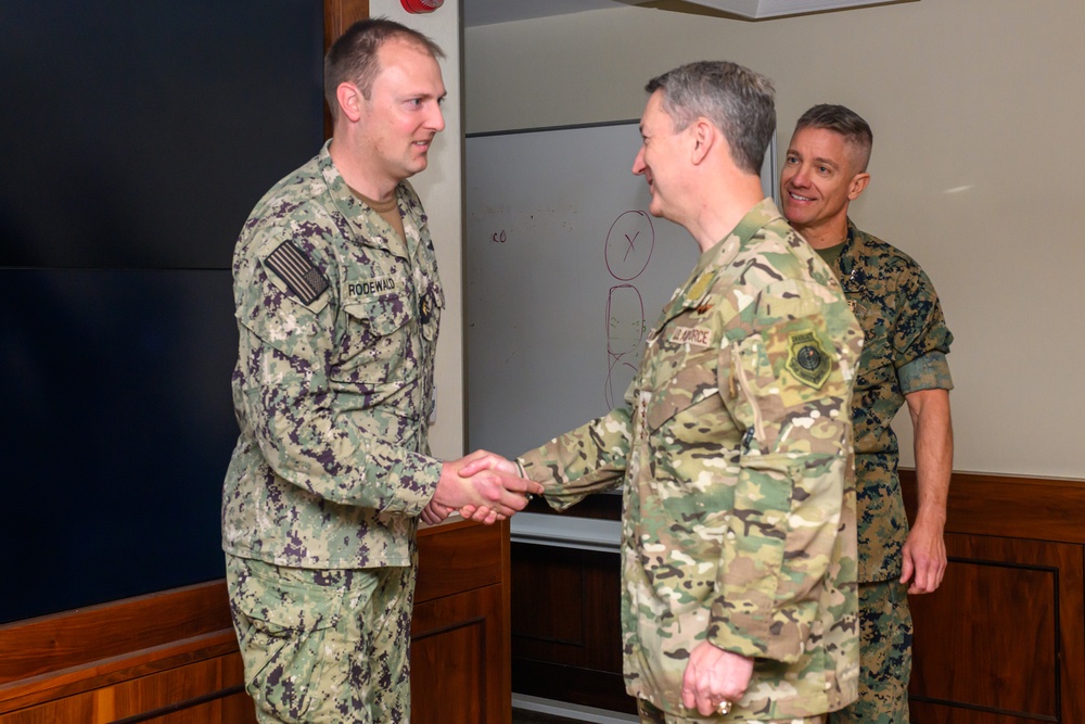 CJCS Gen. Caine greets and presents coins U.S. Africa Command team members