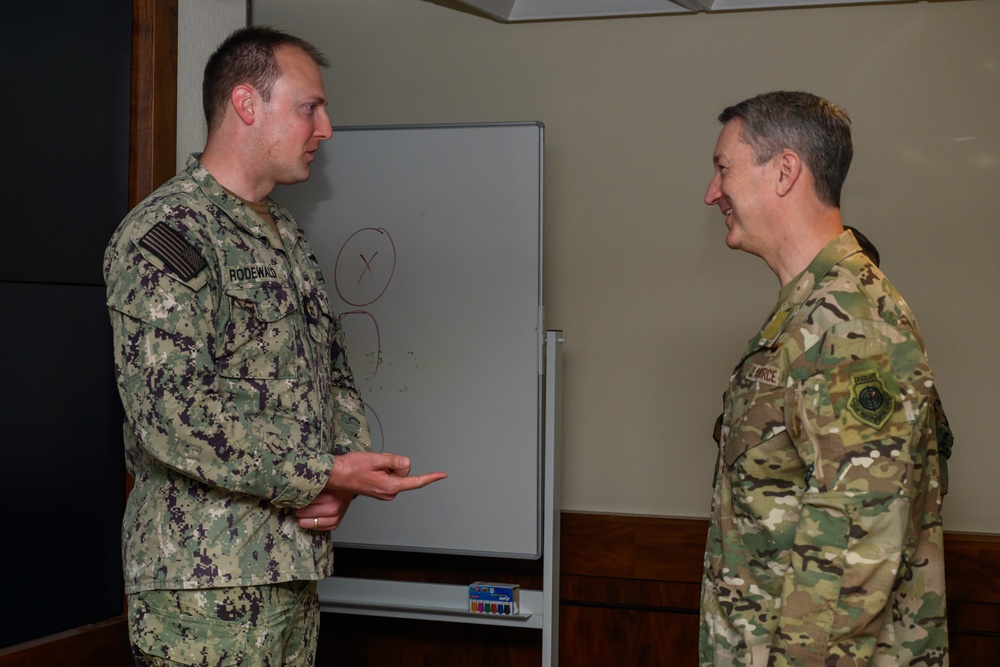 CJCS Gen. Caine greets and presents coins U.S. Africa Command team members