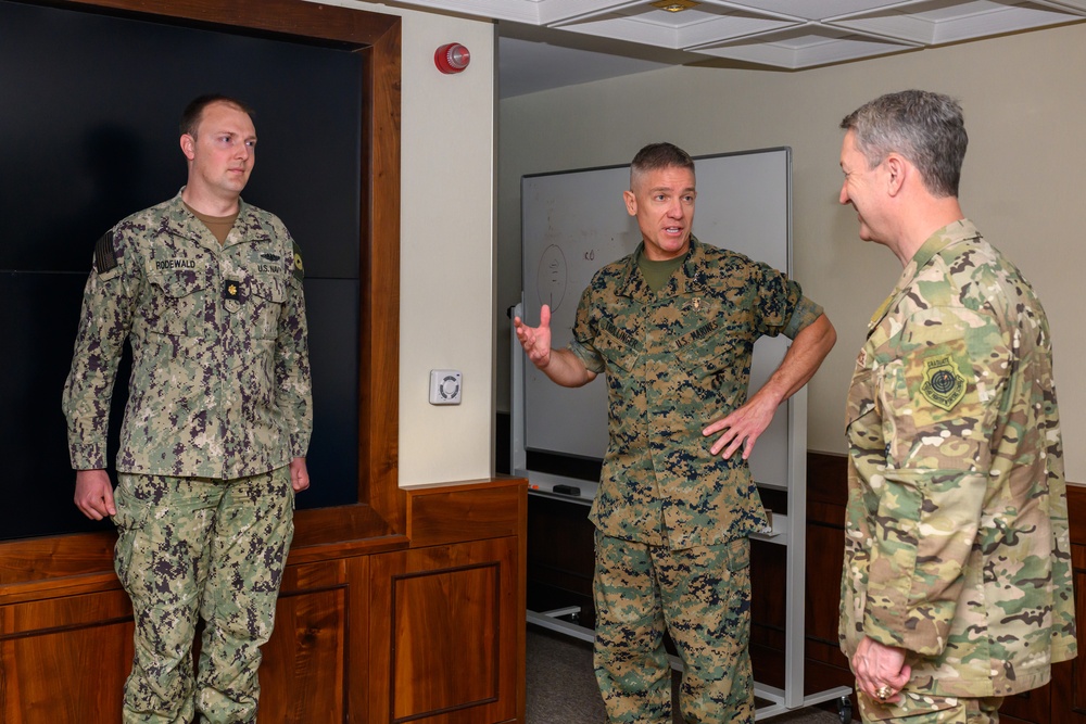 CJCS Gen. Caine greets and presents coins U.S. Africa Command team members