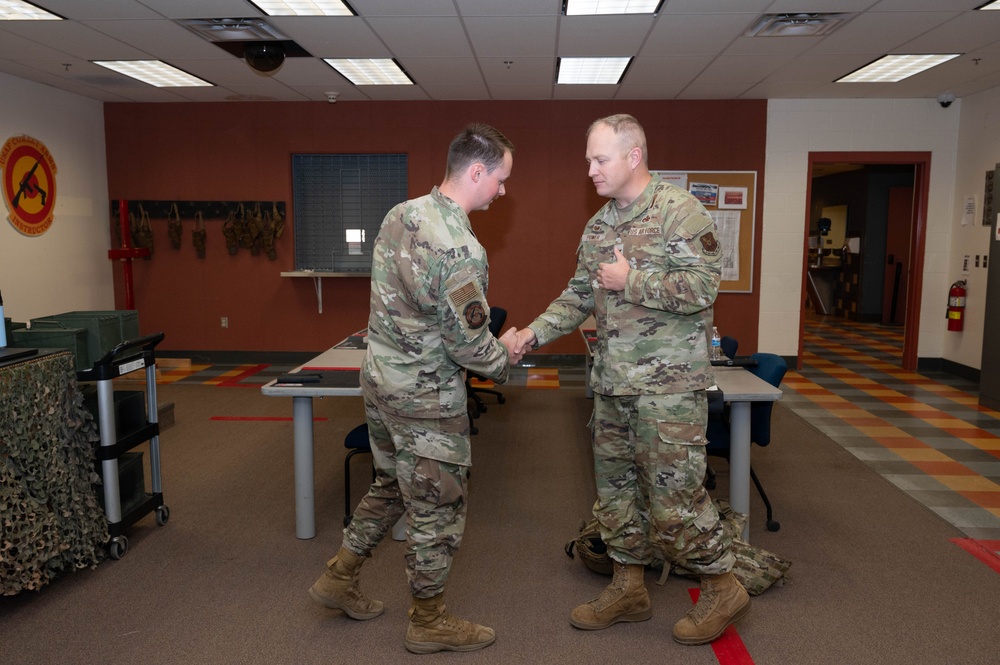 Col. Power Coins Kirtland combat arms instructors