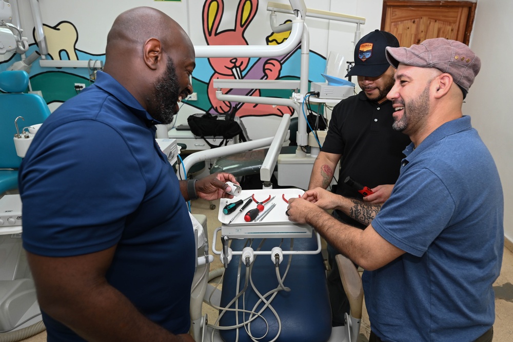 U.S. Navy biomedical technicians collaborate with Panamanian hospital staff to restore dental equipment