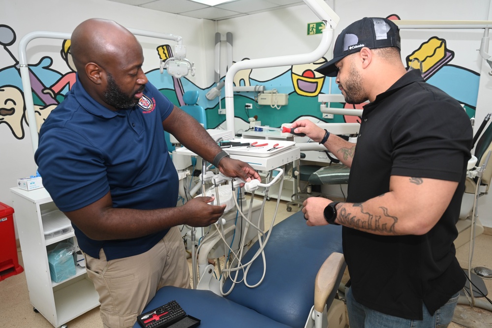 U.S. Navy biomedical technicians collaborate with Panamanian hospital staff to restore dental equipment