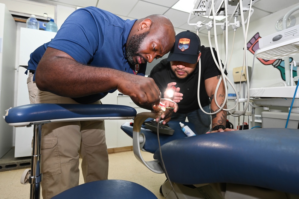 U.S. Navy biomedical technicians collaborate with Panamanian hospital staff to restore dental equipment