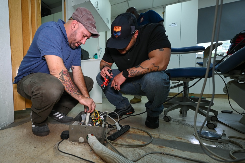 U.S. Navy biomedical technicians collaborate with Panamanian hospital staff to restore dental equipment