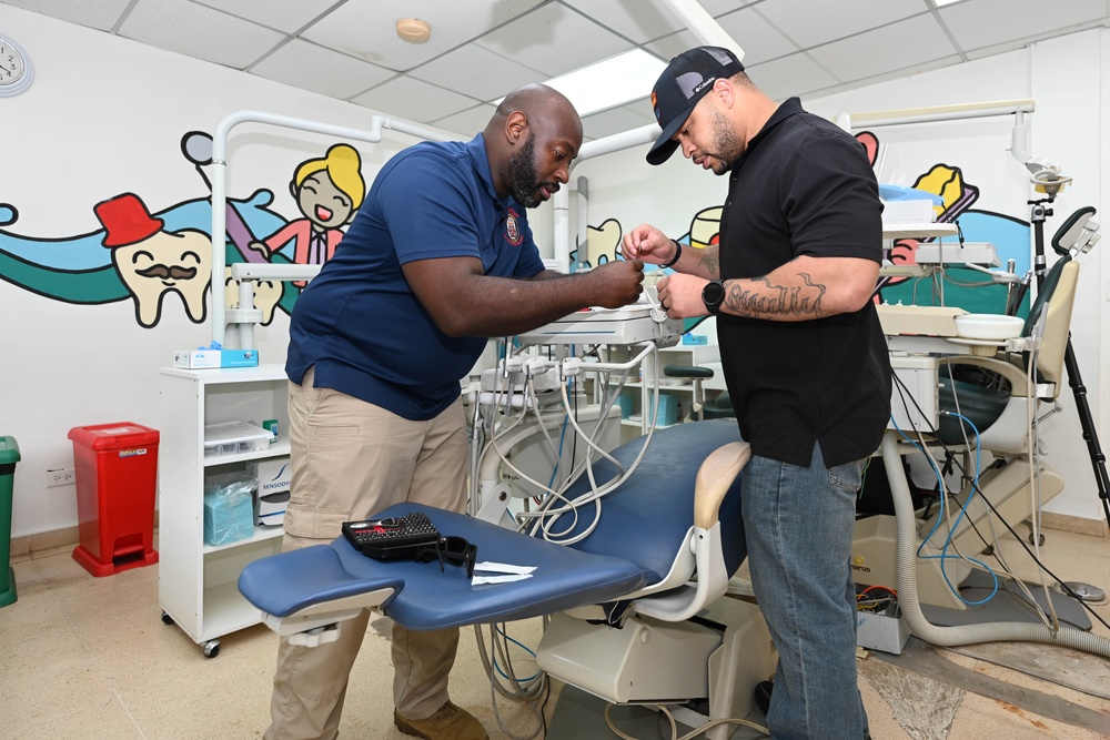 U.S. Navy biomedical technicians collaborate with Panamanian hospital staff to restore dental equipment