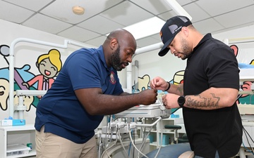 U.S. Navy biomedical technicians collaborate with Panamanian hospital staff to restore dental equipment