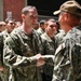 Captain Christopher May presents son with Navy ball cap after Battle Stations evolution at Recruit Training Command.