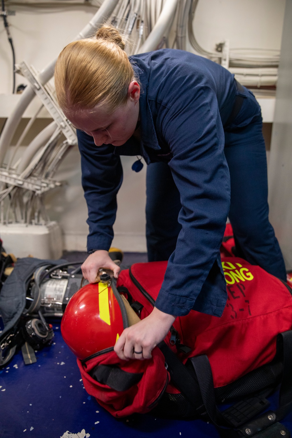 USS Gerald R. Ford (CVN 78) Sailor Stows Firefighting Equipment