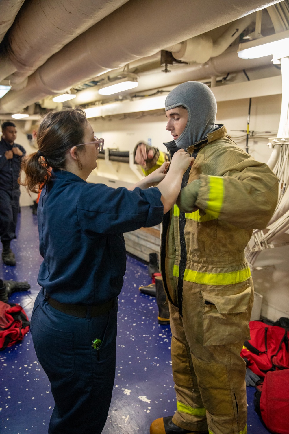 USS Gerald R. Ford (CVN 78) Sailor Dons Firefighting Equipment