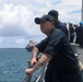 Sailors aboard the USS John Finn conduct a sea and anchor detail in Apra Harbor, Guam