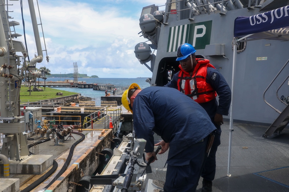 Sailors aboard the USS John Finn conduct a sea and anchor detail in Apra Harbor, Guam