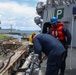 Sailors aboard the USS John Finn conduct a sea and anchor detail in Apra Harbor, Guam