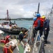 Sailors aboard the USS John Finn conduct a sea and anchor detail in Apra Harbor, Guam
