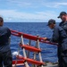 Sailors aboard the USS John Finn conduct a passenger transfer in the Philippine Sea
