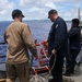 Sailors aboard the USS John Finn conduct a passenger transfer in the Philippine Sea