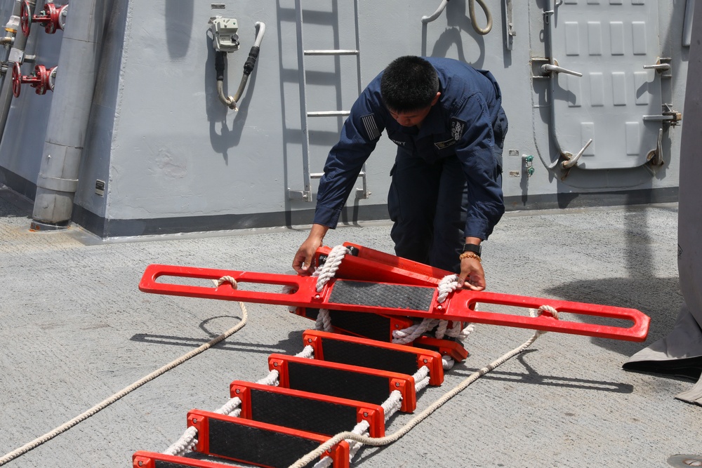 Sailors aboard the USS John Finn conduct a passenger transfer in the Philippine Sea