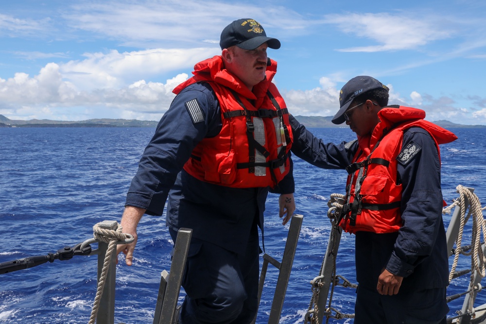 Sailors aboard the USS John Finn conduct a passenger transfer in the Philippine Sea