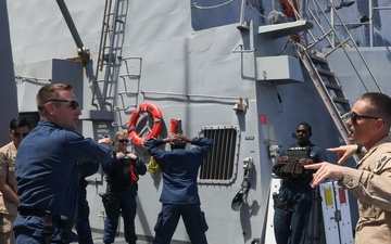 Sailors aboard the USS John Finn hold a security reaction force class in the Philippine Sea