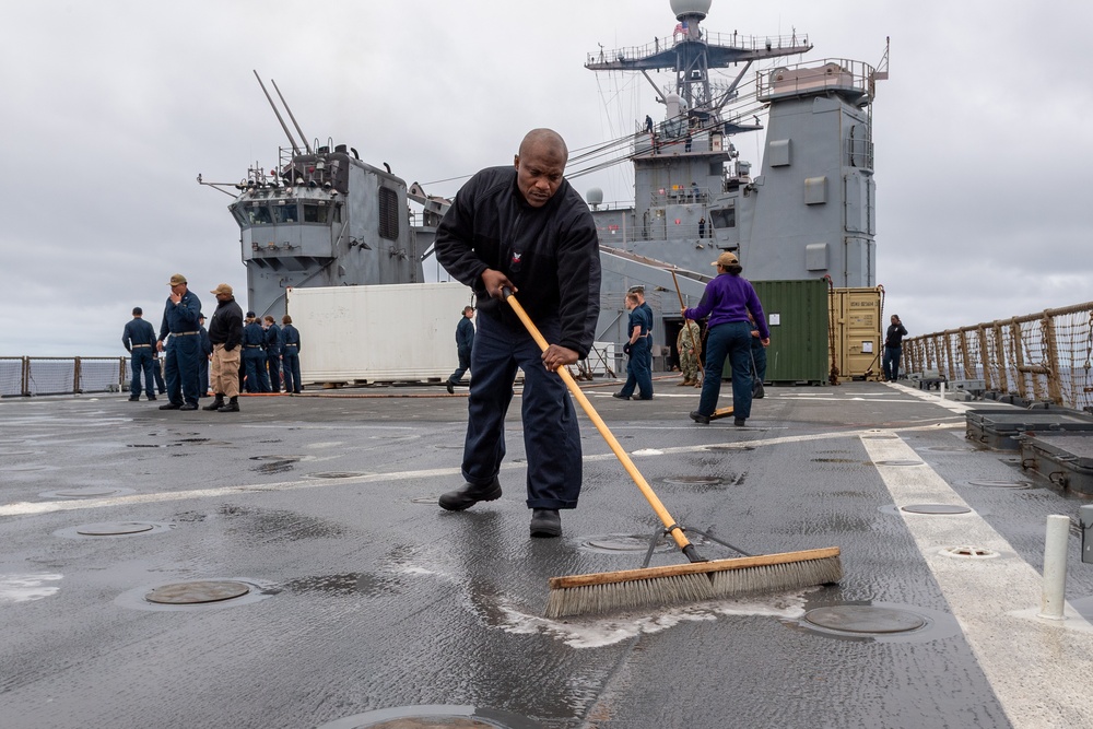 USS PEARL HARBOR (LSD 52) Sailors man the rails as the ship departs for Pacific Partnership 2025