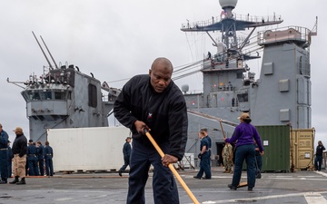 USS PEARL HARBOR (LSD 52) Sailors man the rails as the ship departs for Pacific Partnership 2025