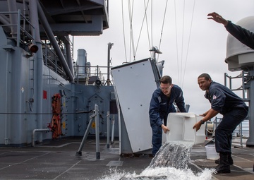 USS PEARL HARBOR (LSD 52) Sailors man the rails as the ship departs for Pacific Partnership 2025