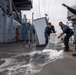 USS PEARL HARBOR (LSD 52) Sailors man the rails as the ship departs for Pacific Partnership 2025