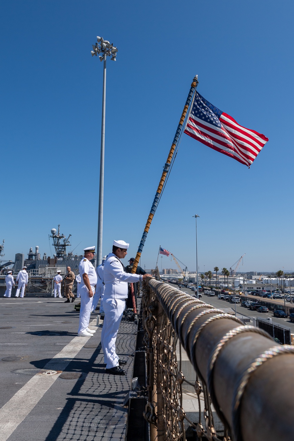 USS PEARL HARBOR (LSD 52) Sailors man the rails as the ship departs for Pacific Partnership 2025