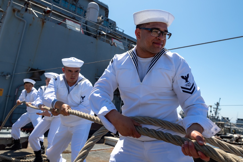 USS PEARL HARBOR (LSD 52) Sailors man the rails as the ship departs for Pacific Partnership 2025