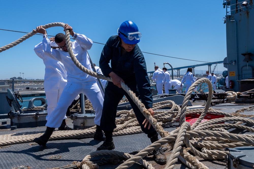 USS PEARL HARBOR (LSD 52) Sailors man the rails as the ship departs for Pacific Partnership 2025