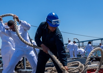 USS PEARL HARBOR (LSD 52) Sailors man the rails as the ship departs for Pacific Partnership 2025