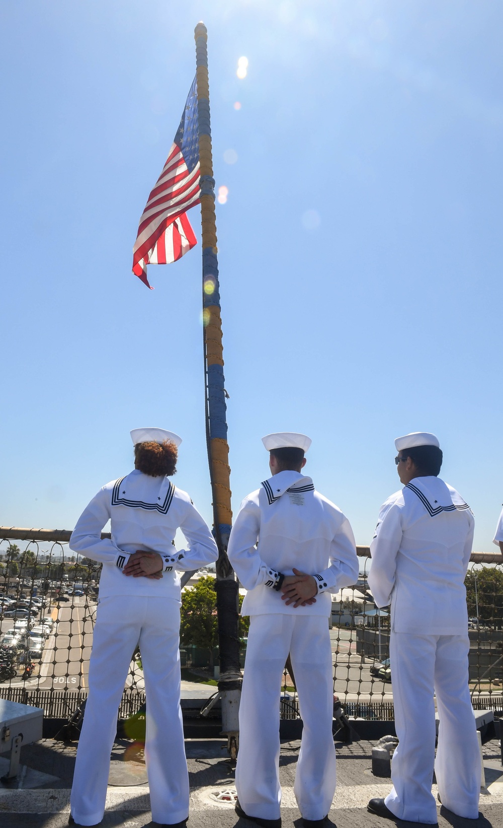 USS PEARL HARBOR (LSD 52) Sailors man the rails as the ship departs for Pacific Partnership 2025
