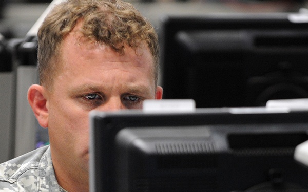 Service Member Monitors Computer During Cyber Guard 2015 Exercise