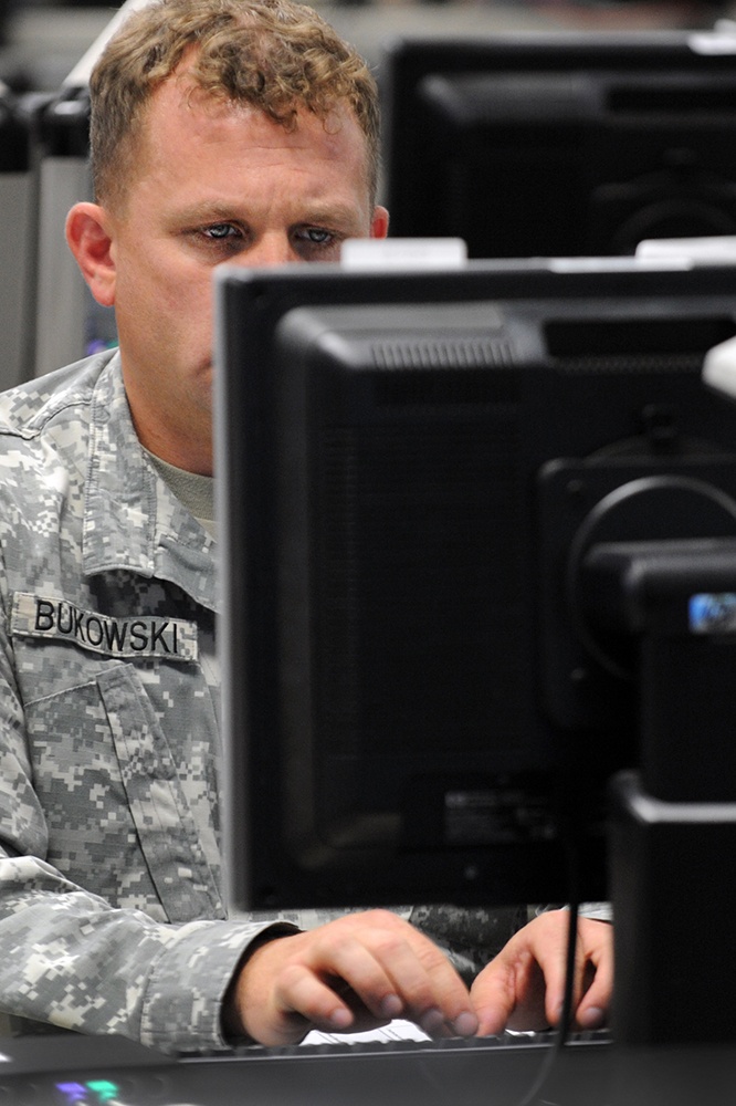 Service Member Monitors Computer During Cyber Guard 2015 Exercise