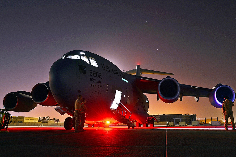 Air Force Crew Chief Prepares for Humanitarian Airdrop Mission in Iraq