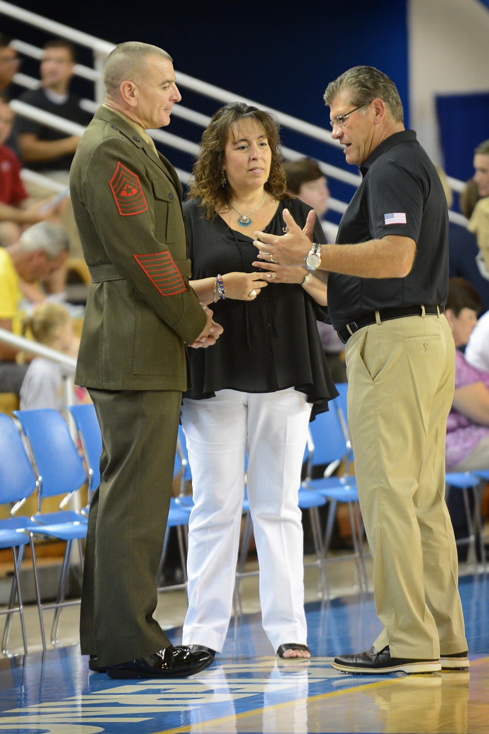 Military Leaders and Women's Basketball Team Exchange Tokens at Exhibition Game
