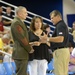 Military Leaders and Women's Basketball Team Exchange Tokens at Exhibition Game