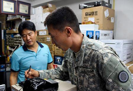 U.S. Army Soldier Purchases Microphone at Seoul Electronics Market